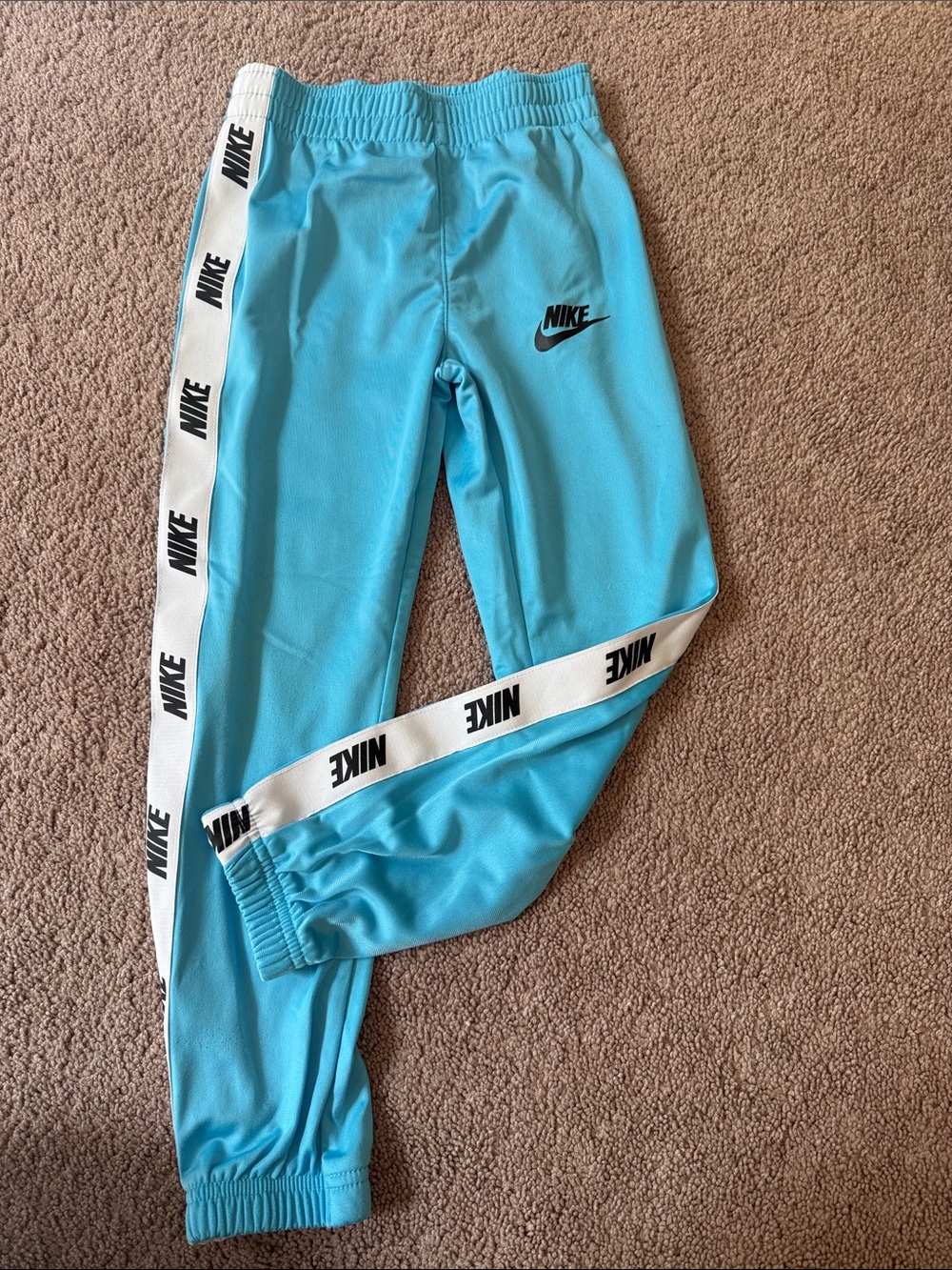 Nike Kids Light Blue Track Joggers with White Logo Tape, size 7